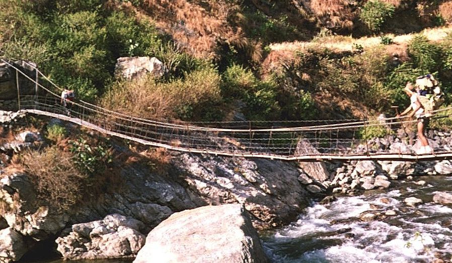 Nepalese Porter crossing Suspension Bridge across the Kabeli Khosi to Yamphudin Village