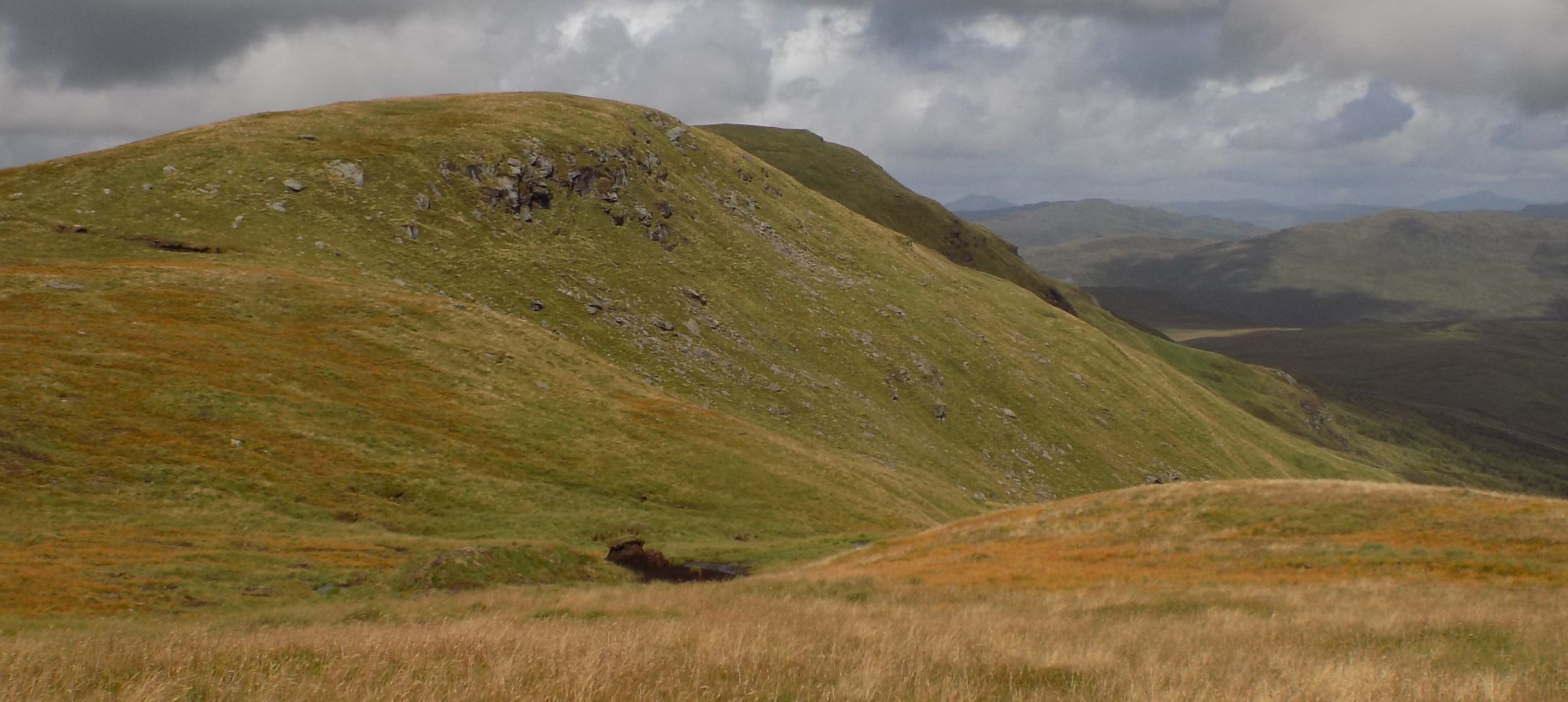 Rock crags beneath summit of Meall Cala